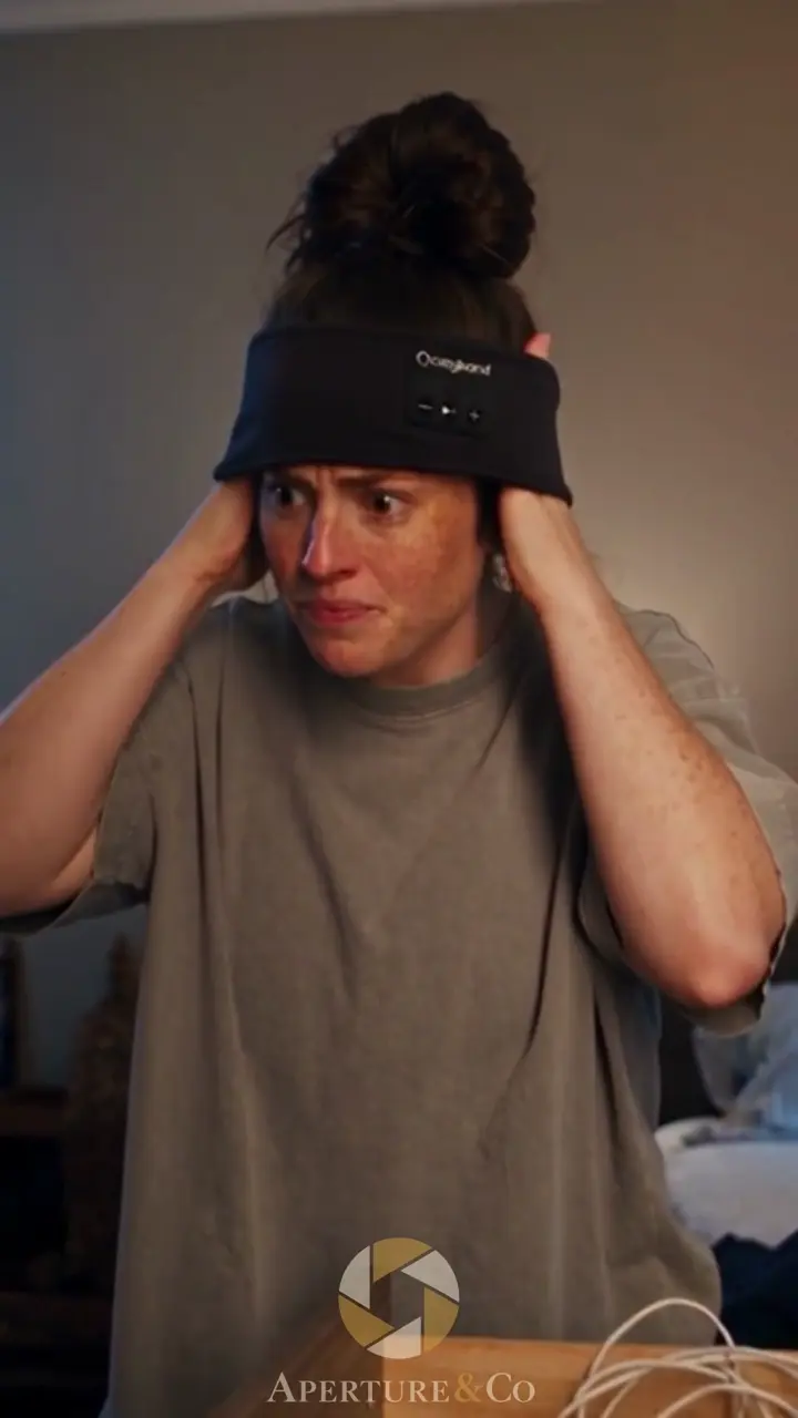 A woman wearing a black sleep headband